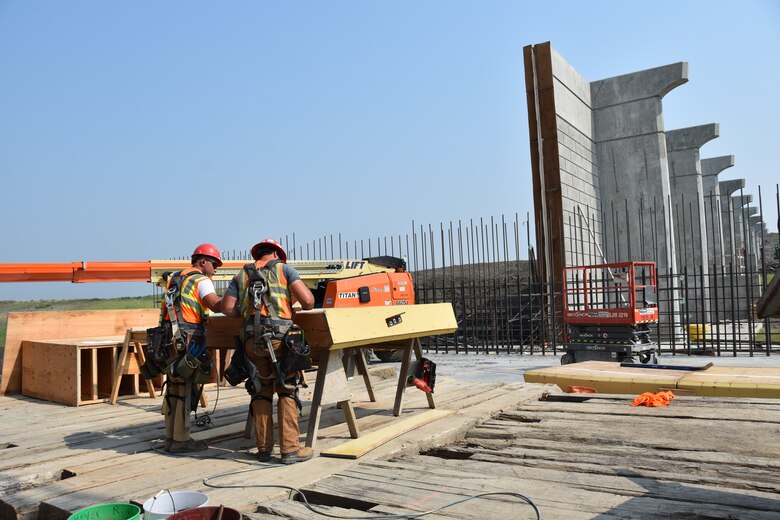 Two men work at a construction site