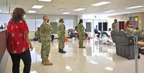 NCDOC Sailors and civilians stand in line waiting to donate during an ASBP blood drive
