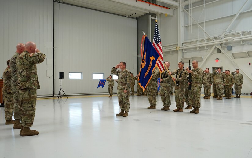 The official party and formation of Soldiers from the Eastern Army National Guard Aviation Training Site salute during the National Anthem played as part of the EAATS change of command ceremony at Fort Indiantown Gap, on August 12, 2021. The ceremony represented the passing of the command of EAATS from Col. Keith Graham, the outgoing commander, to Lt. Col. Randy Lutz, the incoming commander (U.S. Army photo by Sgt. 1st Class Matthew Keeler).