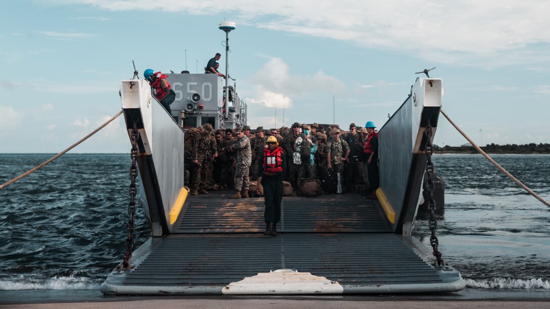 U.S. Marines with 1st Battalion, 6th Marine Regiment (1/6), 2d Marine Division, embark a U.S. Navy landing craft utility with Assault Craft Unit Two in Morehead City, N.C., Aug. 18, 2021. Marines with 1/6 deployed in support of Joint Task Force-Haiti for a humanitarian assistance disaster relief mission. (U.S. Marine Corps photo by Cpl. Patrick King)