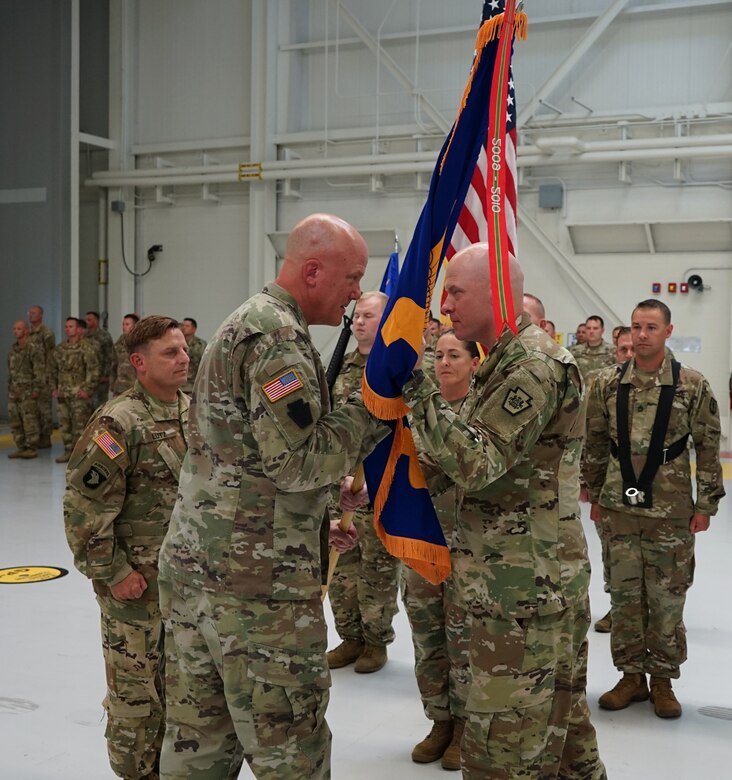 (Left to Right) Brig. Gen. Edwards S. Little, Jr., assistant Adjutant General for the Pennsylvania National Guard, is passed the colors of the Eastern Army National Guard Aviation Training Site from Col. Keith Graham, outgoing commander of EAATS, during a ceremony at Fort Indiantown Gap, on August 12, 2021. The ceremony represented the passing of the command of EAATS from Graham to Lt. Col. Randy Lutz, the incoming commander (U.S. Army photo by Sgt. 1st Class Matthew Keeler).