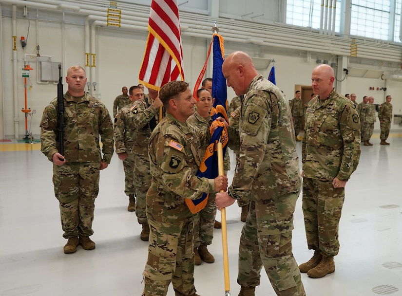 (Left to Right) Lt. Col. Randy Lutz, incoming commander of the Eastern Army National Guard Aviation Training Site, receives the colors of EAATS from Brig. Gen. Edwards S. Little, Jr., assistant Adjutant General for the Pennsylvania National Guard, during the change of command ceremony at Fort Indiantown Gap, on August 12, 2021. The ceremony represented the passing of the command of EAATS from Col. Keith Graham, the outgoing commander, to Lutz (U.S. Army photo by Sgt. 1st Class Matthew Keeler).