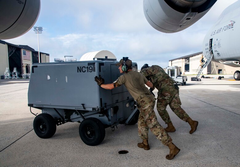 Airman 1st Class Thomas Neiswander, left, and Airman 1st Class Joel Randley, both 436th Aircraft Maintenance Squadron crew chiefs, push a nitrogen cart away from a C-5M Super Galaxy at Dover Air Force Base, Delaware, Aug. 18, 2021. The 436th AMXS Airmen are responsible for the inspection, repair, launch and recovery of Dover AFB’s fleet of C-5M Super Galaxy aircraft. (U.S. Air Force photo by Senior Airman Stephani Barge)