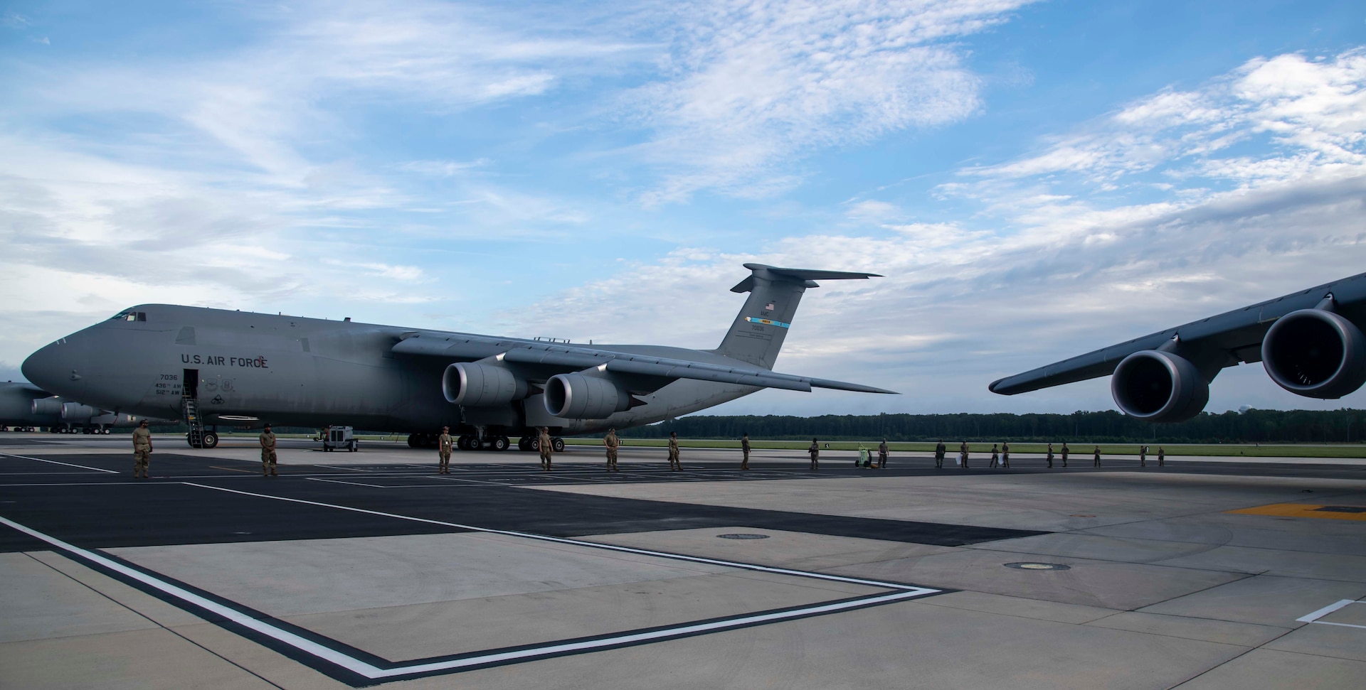 Airmen from the 436th Aircraft Maintenance Squadron perform a foreign object debris walk on the flight line at Dover Air Force Base, Delaware, Aug. 18, 2021. Personnel perform routine FOD walks to clear any objects on the flightline that could potentially cause damage to aircraft. (U.S. Air Force photo by Senior Airman Stephani Barge)