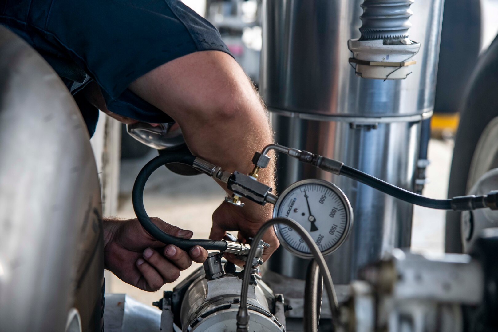 Staff Sgt. Dylan King, 436th Aircraft Maintenance Squadron crew chief, services a landing gear on the C-5M Super Galaxy at Dover Air Force Base, Delaware, Aug. 18, 2021. 436th AMXS Airmen are responsible for the inspection, repair, launch and recovery of Dover AFB’s fleet of C-5M Super Galaxy aircraft. (U.S. Air Force photo by Senior Airman Stephani Barge)