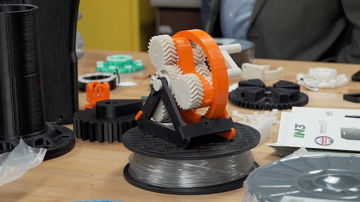 A 3-D printed device sits on a desk.