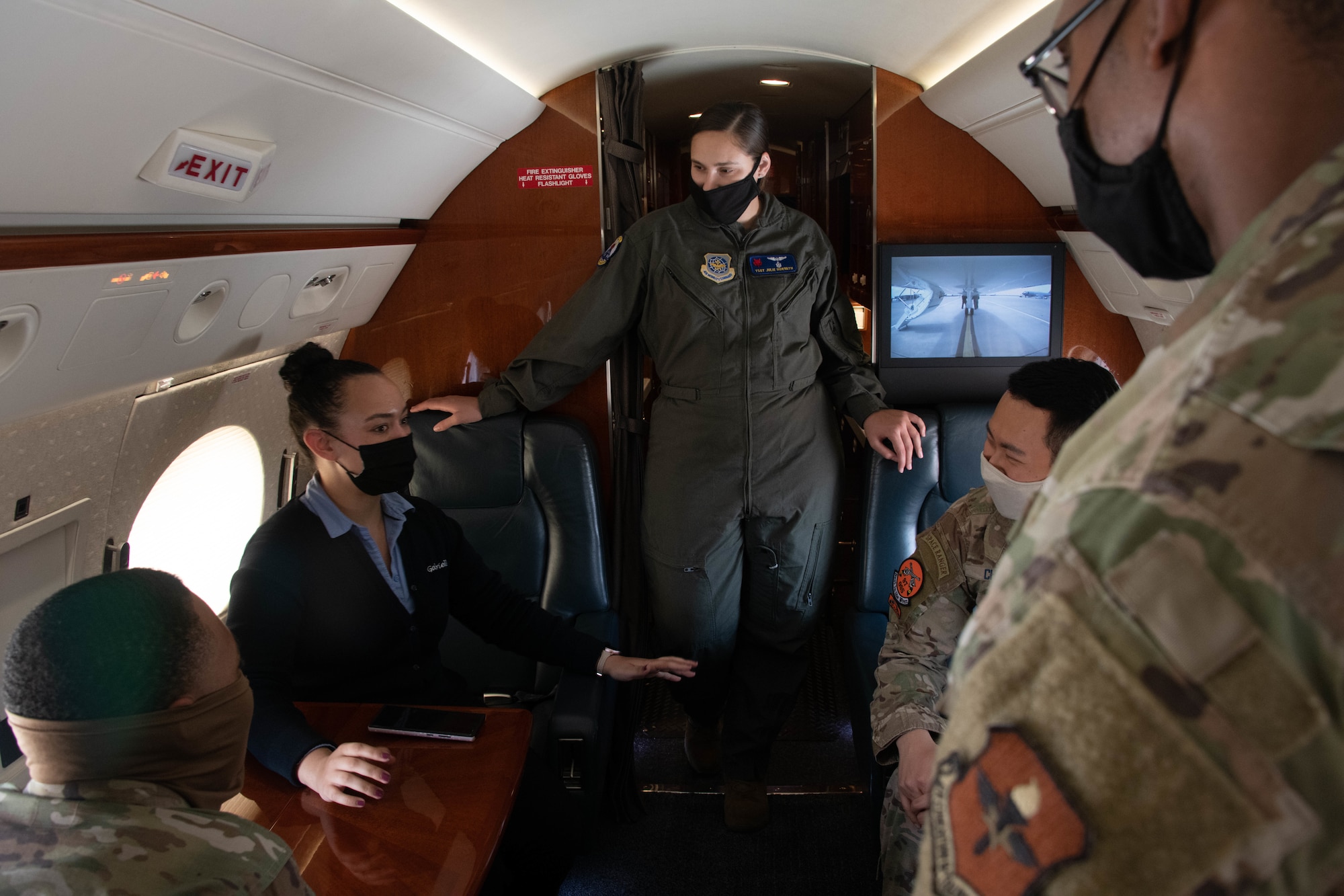 U.S.‌ ‌Air‌ ‌Force‌ ‌Tech.‌ ‌Sgt.‌ ‌Gabriella‌ ‌Cole,‌ ‌1st‌ ‌Airlift‌ ‌Squadron‌ ‌evaluator‌ ‌flight‌ ‌attendant,‌ ‌tells‌ ‌stories‌ ‌from‌ ‌her‌ ‌time‌ ‌with‌ ‌the‌ ‌89th‌ ‌Airlift‌ ‌Wing‌ ‌to‌ ‌Airmen‌ ‌from‌ ‌the‌ ‌97th‌ ‌Air‌ ‌Mobility‌ ‌Wing‌ ‌on‌ ‌Altus‌ ‌Air‌ ‌Force‌ ‌Base,‌ ‌Oklahoma,‌ ‌Aug.‌ ‌13,‌ ‌2021.‌ ‌While‌ ‌on‌ ‌their‌ ‌missions,‌ ‌flight‌ ‌attendants‌ ‌plan‌ ‌and‌ ‌prepare‌ ‌meals‌ ‌for‌ ‌distinguished‌ ‌guests‌ ‌and‌ ‌their‌ ‌staff‌ ‌while‌ ‌also‌ ‌ensuring‌ ‌safety‌ ‌and‌ ‌comfortability‌ ‌during‌ ‌their‌ ‌secure‌ ‌transportation‌ ‌across‌ ‌the‌ ‌globe.‌ ‌(U.S.‌ ‌Air‌ ‌Force‌ ‌photo‌ ‌by‌ ‌Airman‌ ‌1st‌ ‌Class‌ ‌Trenton‌ ‌Jancze)‌