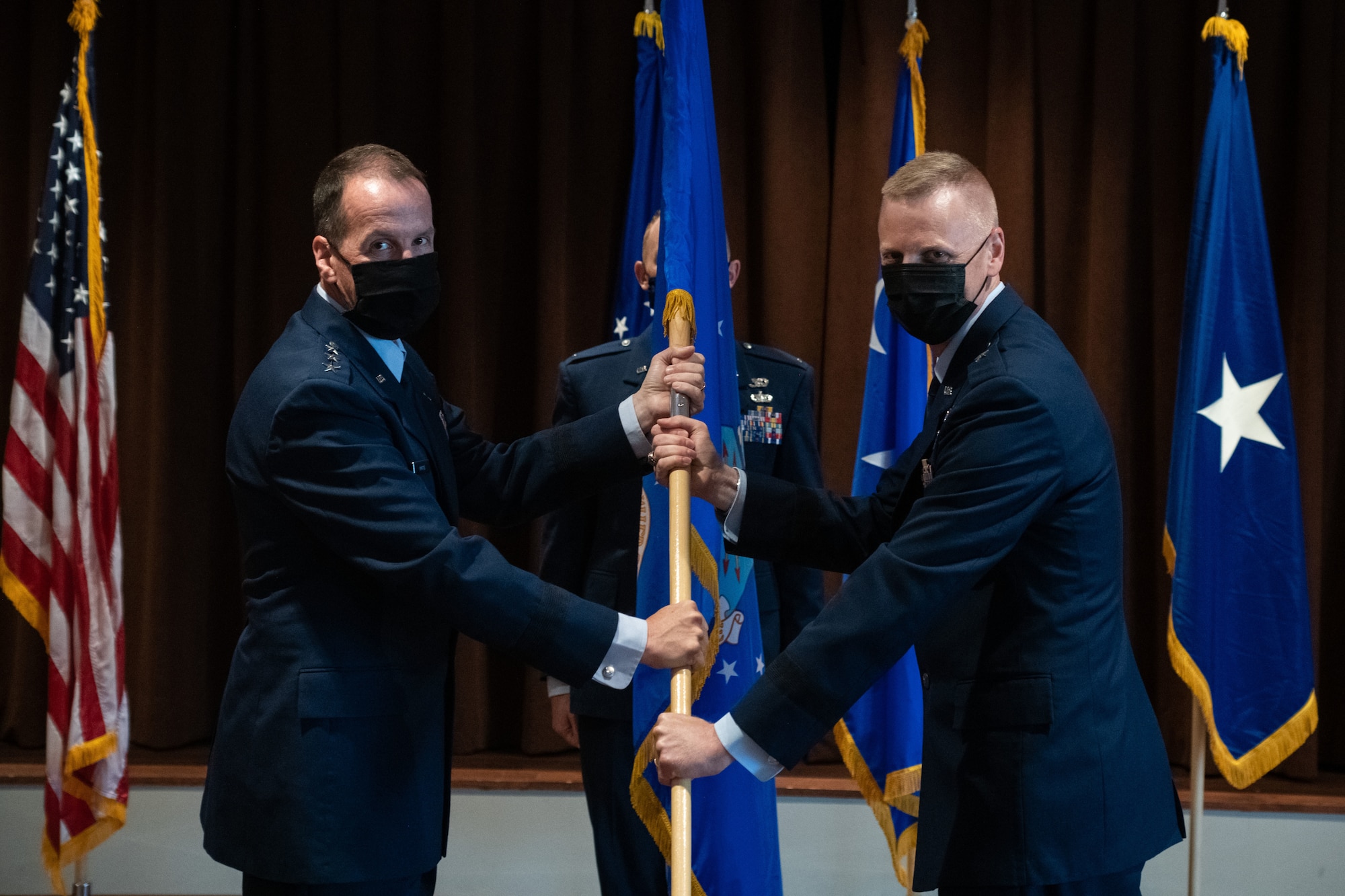 Lt. Gen. Shaun Q. Morris, Air Force Life Cycle Management Center commander, presents the guidon to Brig. Gen. Luke Cropsey, Air Force Security Assistance and Cooperation Directorate Director, during the AFSAC Change of Leadership Ceremony at the Wright-Patterson Club, August 13, 2021. The ceremony is a symbol of leadership being exchanged from one director to the next. Cropsey assumed leadership of AFSAC from Brig. Gen. Brian Bruckbauer. (U.S. Air Force photo by Tech. Sgt. Matthew B. Fredericks)