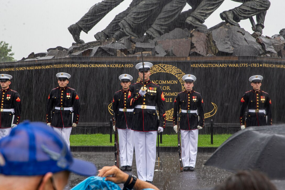 Sergeant Chase Furlough, platoon sergeant, Silent Drill Platoon, renders a salute during an Honor Flight performance at the Marine Corps War Memorial, Arlington, Va., Aug. 18, 2021.