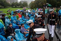 Marines with the Silent Drill Platoon greet veterans following an Honor Flight performance at the Marine Corps War Memorial, Arlington, Va., Aug. 18, 2021.