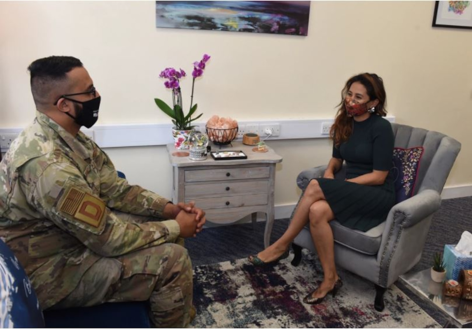 U.S. Air Force Staff Sgt. Abdul Sadiq, 100th Security Forces Squadron and Square D Character, Culture and Community administrative support, chats with Dr. Karen Kuemerle-Pinillos, 100th Air Refueling Wing licensed clinical social worker, in the BRIEF Therapy area in the DC3 building at RAF Mildenhall, England, Aug. 2, 2021. The program – Behavioral solutions Refined by Identified problems for Emotional health and Focused goals –helps clients with issues such as stress, anger management and relationship issues. (U.S. Air Force photo by Karen Abeyasekere)