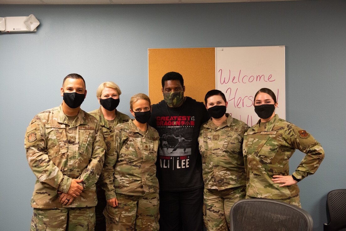 Herschel Walker poses with members of the 47th Medical Group on Aug. 18, 2021 at Laughlin Air Force Base, Texas. Walker talked with the staff about mental health, how it affects air force military members and what Laughlin AFB is doing to help their members work through these struggles by providing them with multiple resources to reach out to, such as the Mental Health Clinic and family life counselors at the Airman Family Readiness Center. (U.S. Air Force photo by Airman Kailee Reynolds)