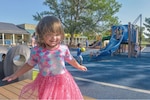 Georgia shows off for the camera during recess on Mountain Home Air Force Base, Idaho, August 10, 2021. After containing a recent COVID-19 outbreak within the Child Development Center, all programs and facilities were fully re-opened after careful monitoring by the Public Health team. (U.S. Air Force photo by Senior Airman Austin Siegel)