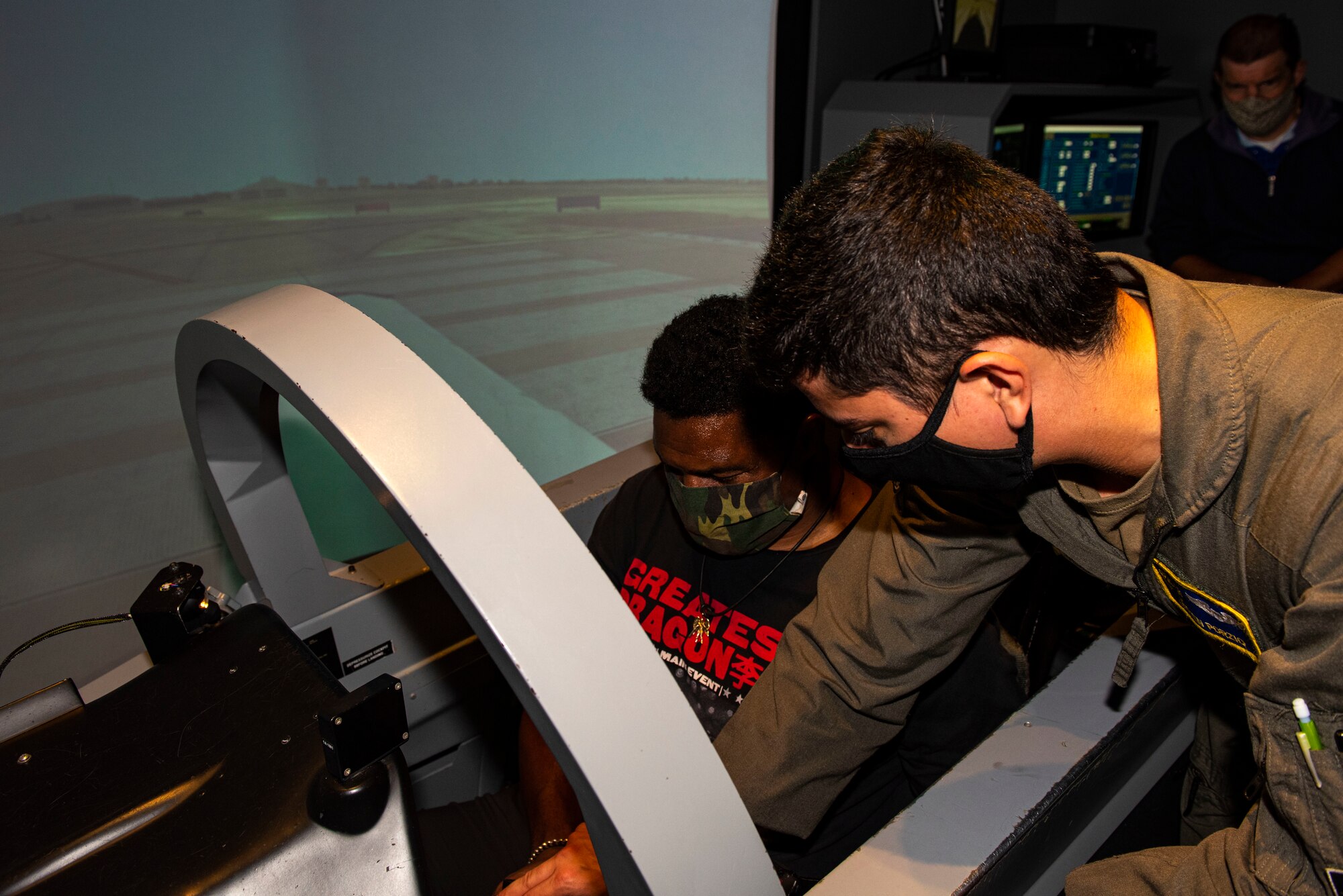 Herschel Walker pilots a Texan II T-6 simulator attempts to achieve lift off on Aug. 18, 2021 at Laughlin Air Force Base. The purpose was to discuss mental health, many service members and veterans suffer from mental illness and have many options for them to use to help them through those times such as the mental health clinic, military family life counselors at Airman Family Readiness Center, and the chaplain additionally, veterans can contact Veterans Affairs. (U.S. Air Force photo by David Phaff)