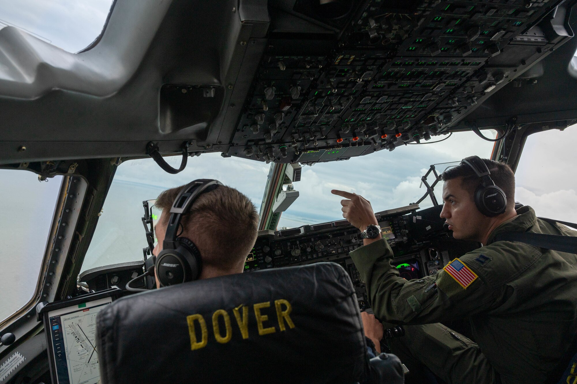 Capt. Steve Tice, right, 436th Operations Support Squadron chief of tactics, points to a 25-man survival raft from a C-17 Globemaster III during Exercise Castaway, Aug. 4, 2021. Exercise Castaway is an interagency training exercise that brought Airmen from Dover AFB and two coast guard stations, Coast Guard Air Station Atlantic City, New Jersey, and Coast Guard Station Indian River Inlet, Delaware, together to train local search and rescue procedures. (U.S. Air Force photo by Senior Airman Faith Schaefer)