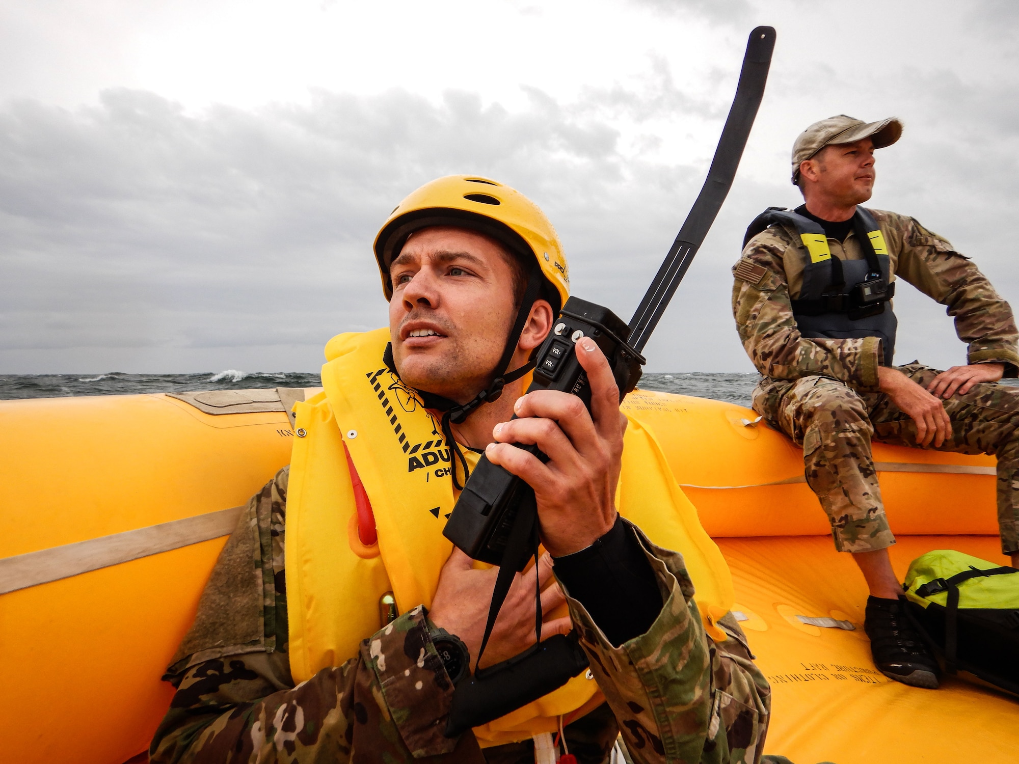 U.S. Army Capt. Spencer Diamond, exercise participant, talks to pilots aboard a C-17 Globemaster III through a combat survivor evader locator near Coast Guard Station Indian River Inlet, Delaware, Aug. 4, 2021. The crew aboard the life raft used several signaling devices like the CSEL radio, sea dye, life raft canopy and flare to vector the C-17 to their location. (U.S. Air Force photo by Senior Airman Marco A. Gomez)