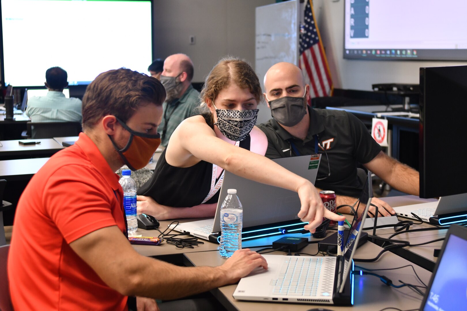 IMAGE: (Left to right) NSWCDD Integrated Combat Systems employees Justin Foulks, Katelyn Barbre and Brandon Marine troubleshoot their solution at the NSWCDD Innovation Lab’s wargaming hackathon on Aug. 11. Teams used their artificial intelligence and machine learning backgrounds to compete against other departments at the event Aug.11-13.