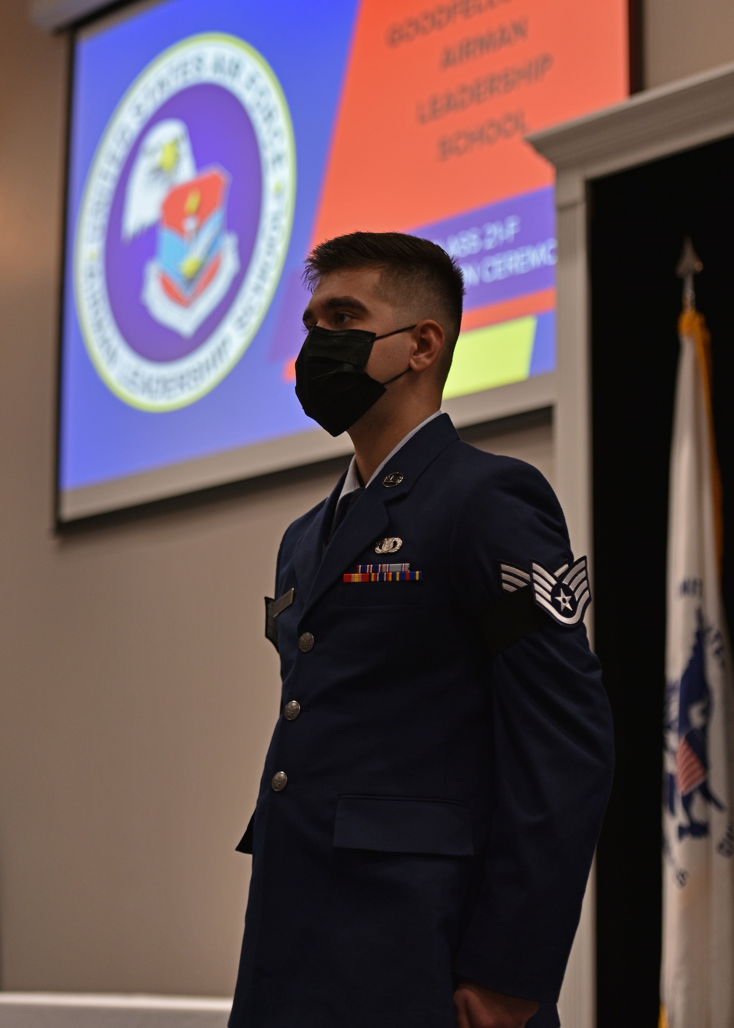 U.S. Air Force Senior Airman Hans Pranschke, 47th Flying Training Wing command post controller, stands at attention while the Non-Commissioned Officer Charge is recited during Pranschke’s Airman Leadership School graduation ceremony on Goodfellow Air Force Base, Texas, Aug. 19, 2021. The NCO Charge states the additional responsibilities and authorities willingly accepted by every NCO. (U.S. Air Force photo by Senior Airman Ashley Thrash)