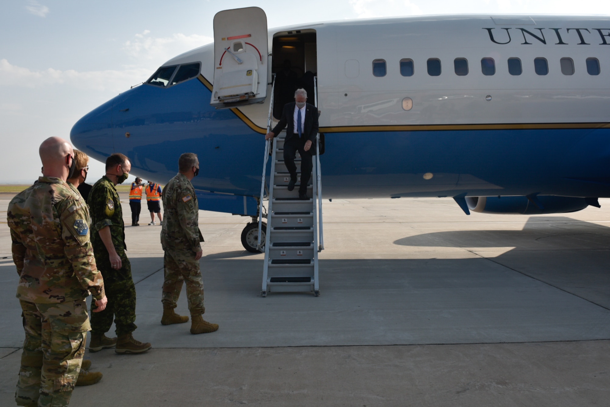 SECAF Frank Kendall is greeted by peterson leadership as he exits his plane