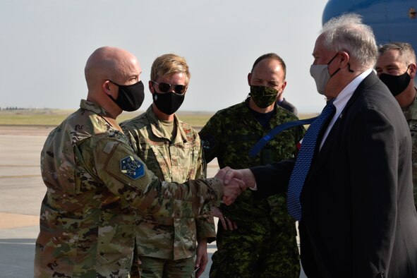 Secretary of the Air Force Frank Kendall is greeted by U.S. Space Force Col. Zachary Warakomski, Peterson-Schriever Garrison commander, upon his arrival at Peterson Space Force Base, Colorado, Aug. 18, 2021.  The P-S GAR mission is to evolve space and cyberspace warfighting superiority through integrated and innovative operations. (U.S. Space Force photo by Airman 1st Class Alexis Christian)
