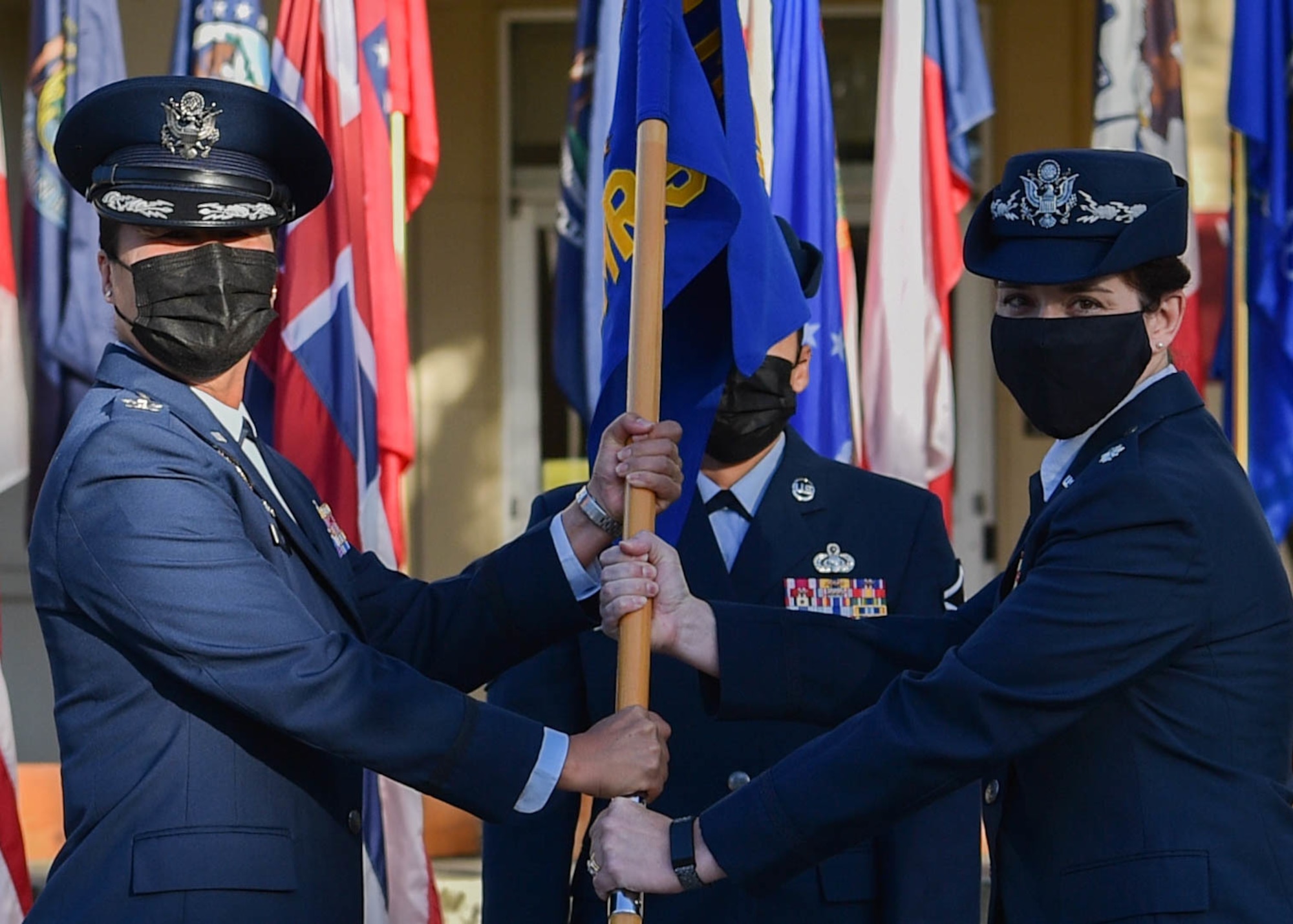Lt. Col. Shawn Garcia, assumes command of the 15th Operational Medical Readiness Squadron by accepting the guidon from Col. Stephanie Ku, 15th Medical Group commander, during an assumption of command ceremony at Joint Base Pearl Harbor-Hickam, Hawaii, Aug. 18, 2021. The 15th OMRS consists of seven flights, each with a specific function providing medical care to active-duty Airmen. (U.S. Air Force photo by Senior Airman Alan Ricker)