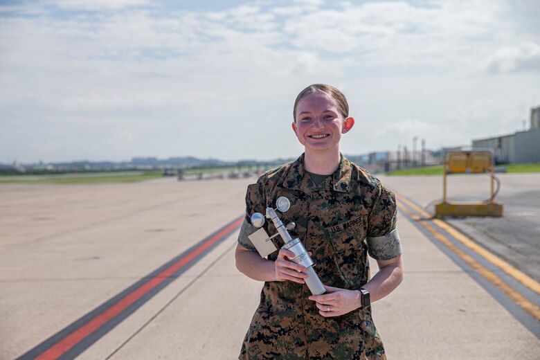 U.S. Marine Corps Cpl. Julia Hubler, a meteorological and oceanography (METOC) analyst forecaster with Headquarters and Headquarters Squadron, Marine Corps Air Station (MCAS) Futenma, poses for an environmental portrait on MCAS Futenma, Okinawa, Japan, Aug. 9, 2021. METOC analyst forecasters analyze atmospheric, space, climatic and hydrologic intelligence which is used to make and brief tactical recommendations to commanders. Hubler is a native of Gore, Oklahoma. (U.S. Marine Corps photo by Lance Cpl. Alex Fairchild)