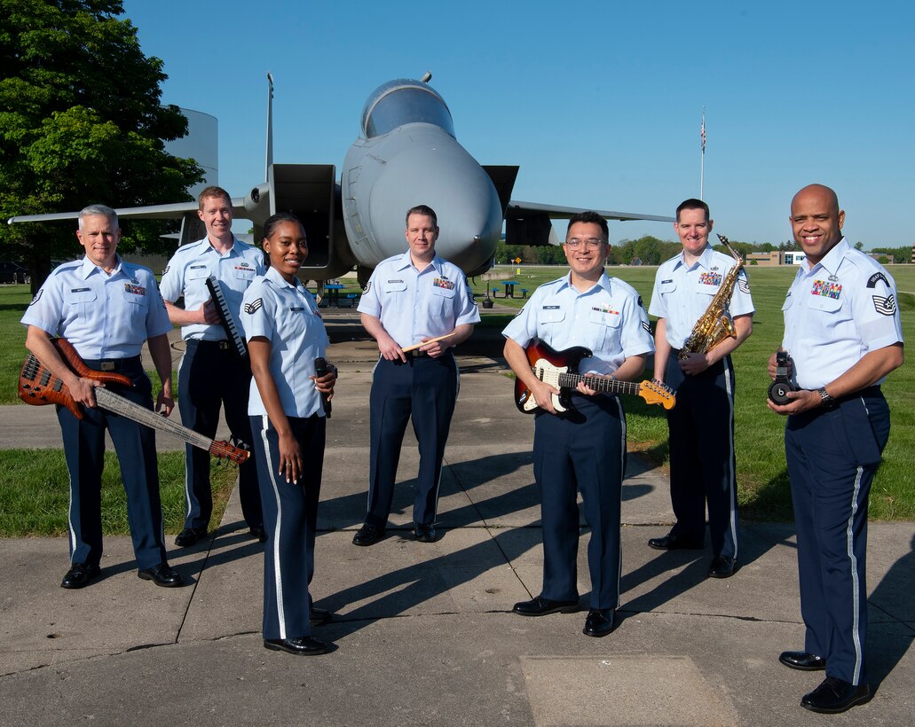 Members of the Air Force Band of Flight’s rock ensemble Flight One pose May 14, 2021, in front of an F-15 Eagle fighter on display at the National Museum of the U.S. Air Force on Wright-Patterson Air Force Base, Ohio. (U.S. Air Force photo by R.J. Oriez)