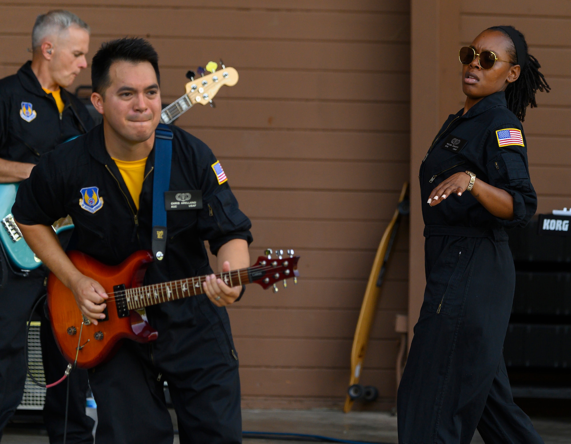 Airman 1st Class Christopher Arellano (foreground), Tech. Sgt. Joseph Whitt and Senior Airman MeLan Smartt jam during a performance of Flight One, an Air Force rock band, on Aug. 13, 2021, at Centerville Community Amphitheater in Stubbs Park, Centerville, Ohio. (U.S. Air Force photo by R.J. Oriez)