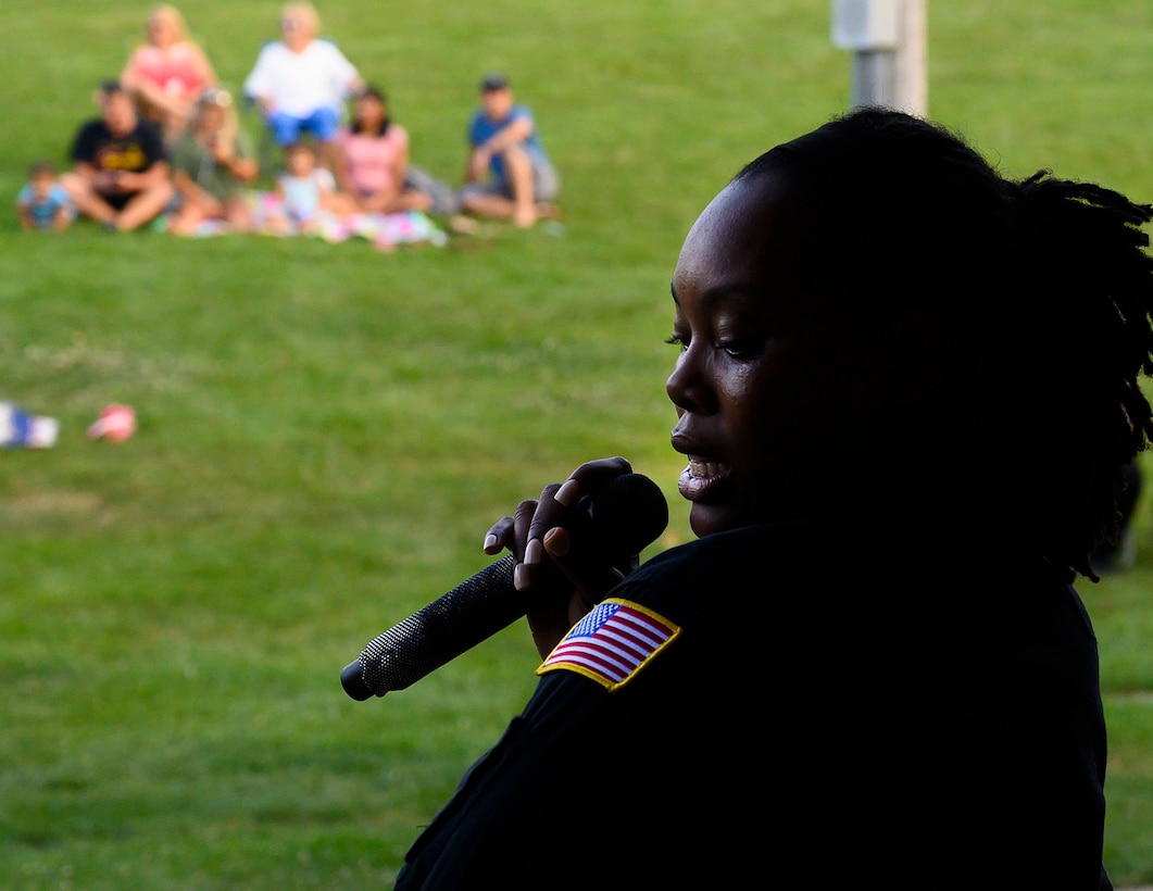Senior Airman MeLan Smartt, Flight One vocalist, sings to the audience during a show Aug. 13, 2021, at Centerville Community Amphitheater in Stubbs Park, Centerville, Ohio. Smartt was teaching high school when she saw a flyer announcing auditions for the Air Force Band Program, and she decided to give it a shot. (U.S. Air Force photo by R.J. Oriez)