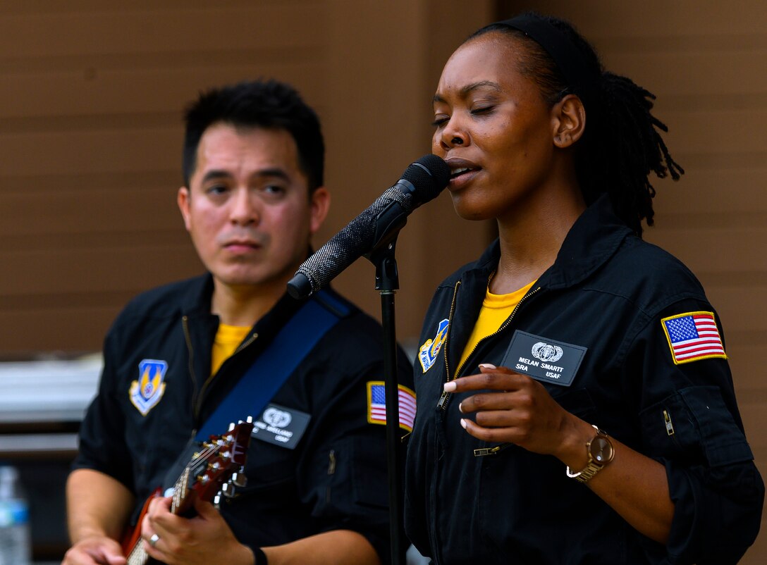 Senior Airman MeLan Smartt and Airman 1st Class Christopher Arellano perform the Etta James classic “At Last” at Centerville Community Amphitheater in Stubbs Park, Centerville, Ohio, on Aug. 13, 2021, as part of a concert by Flight One, the Air Force Band of Flight rock ensemble stationed at Wright-Patterson Air Force Base. (U.S. Air Force photo by R.J. Oriez)