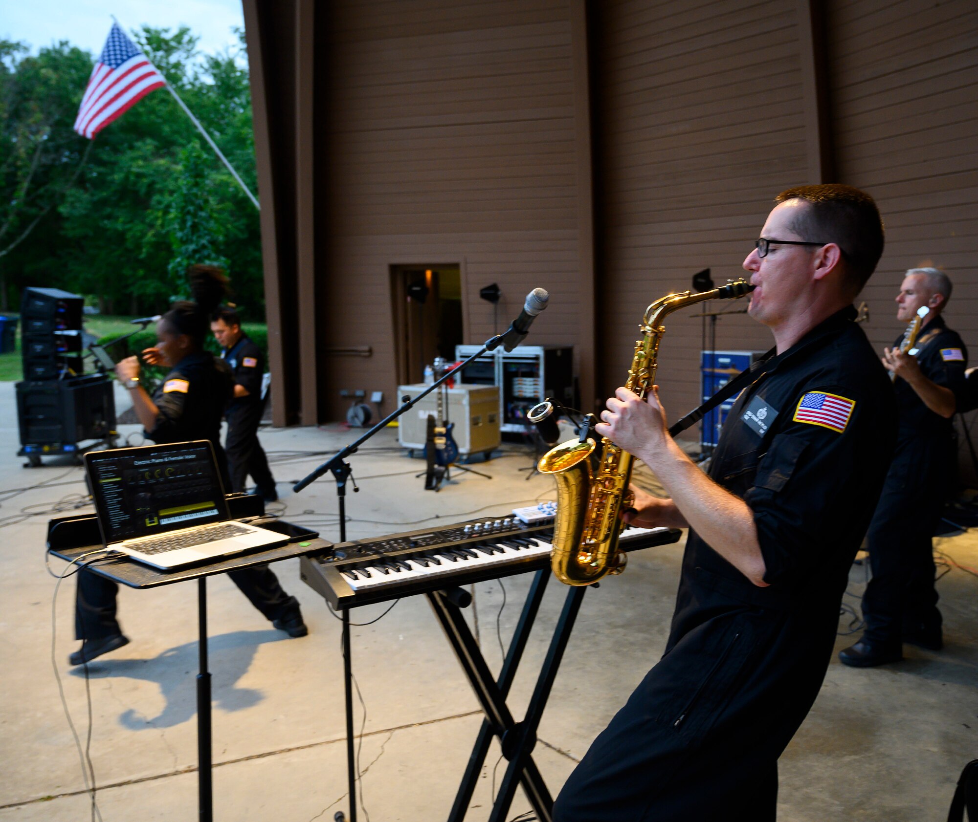ech. Sgt. Greg Pflugh plays the saxophone during a performance by Flight One, an Air Force rock band, on Aug. 13, 2021, at Centerville Community Amphitheater in Stubbs Park, Centerville, Ohio. In the course of the show, Pflugh played the sax, keyboard and guitar. He is also the band’s music director. (U.S. Air Force photo by R.J. Oriez)