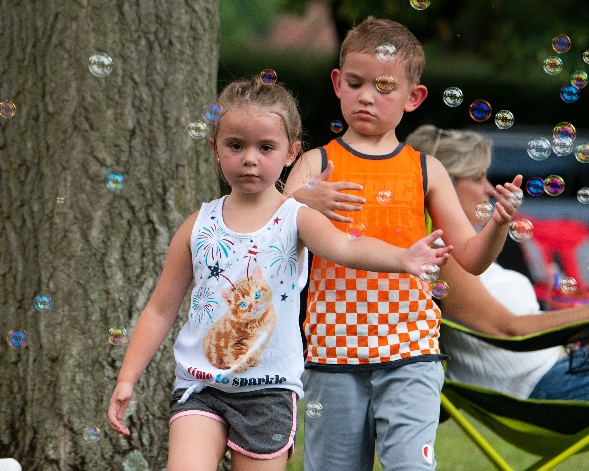 Lily, 5, and Skyler, 7, the children of 1st Lt. Brandon and Amber McVey, play amongst the bubbles at a block party Aug. 12, 2021, put on by the 88th Force Support Squadron in the historic Brick Quarters housing area at Wright-Patterson Air Force Base, Ohio. The party was the middle in a summer series of three sponsored by 88 FSS for Wright-Patt community members. (U.S. Air Force photo by R.J. Oriez)
