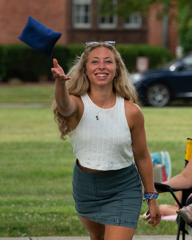 Lauren Schrank plays cornhole against her husband, 2nd Lt. Alec Schrank, a graduate student at the Air Force Institute of Technology, during a block party Aug. 12, 2021, put on by the 88th Force Support Squadron in the historic Brick Quarters housing area at Wright-Patterson Air Force Base, Ohio. The event, free for all Wright-Patt community members, featured live music, games and a food truck. (U.S. Air Force photo by R.J. Oriez)