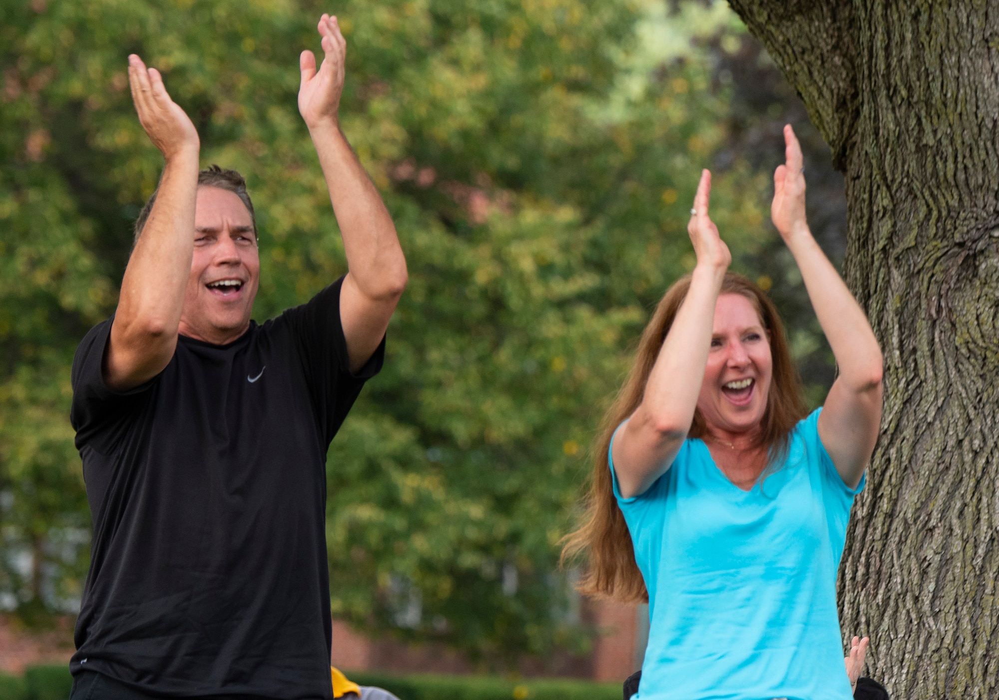 Tim Taylor  and Michelle Spangler applaud the rock band Stranger at the end of its show Aug. 12, 2021, during a block party put on by the 88th Force Support Squadron in the historic Brick Quarters housing area at Wright-Patterson Air Force Base, Ohio. The event, free for all Wright-Patt community members, featured live music, games and a food truck. Taylor is a civilian employee of the National Air and Space Intelligence Center. (U.S. Air Force photo by R.J. Oriez)