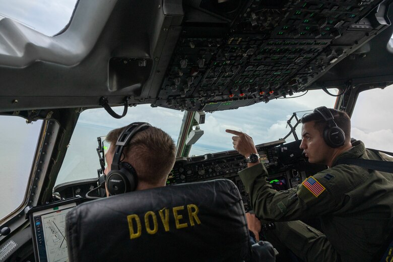 Capt. Steve Tice, right, 436th Operations Support Squadron chief of tactics, points to a 25-man survival raft from a C-17 Globemaster III during Exercise Castaway, Aug. 4, 2021. Exercise Castaway is an interagency training exercise that brought Airmen from Dover AFB and two coast guard stations, Coast Guard Air Station Atlantic City, New Jersey, and Coast Guard Station Indian River Inlet, Delaware, together to train local search and rescue procedures. (U.S. Air Force photo by Senior Airman Faith Schaefer)