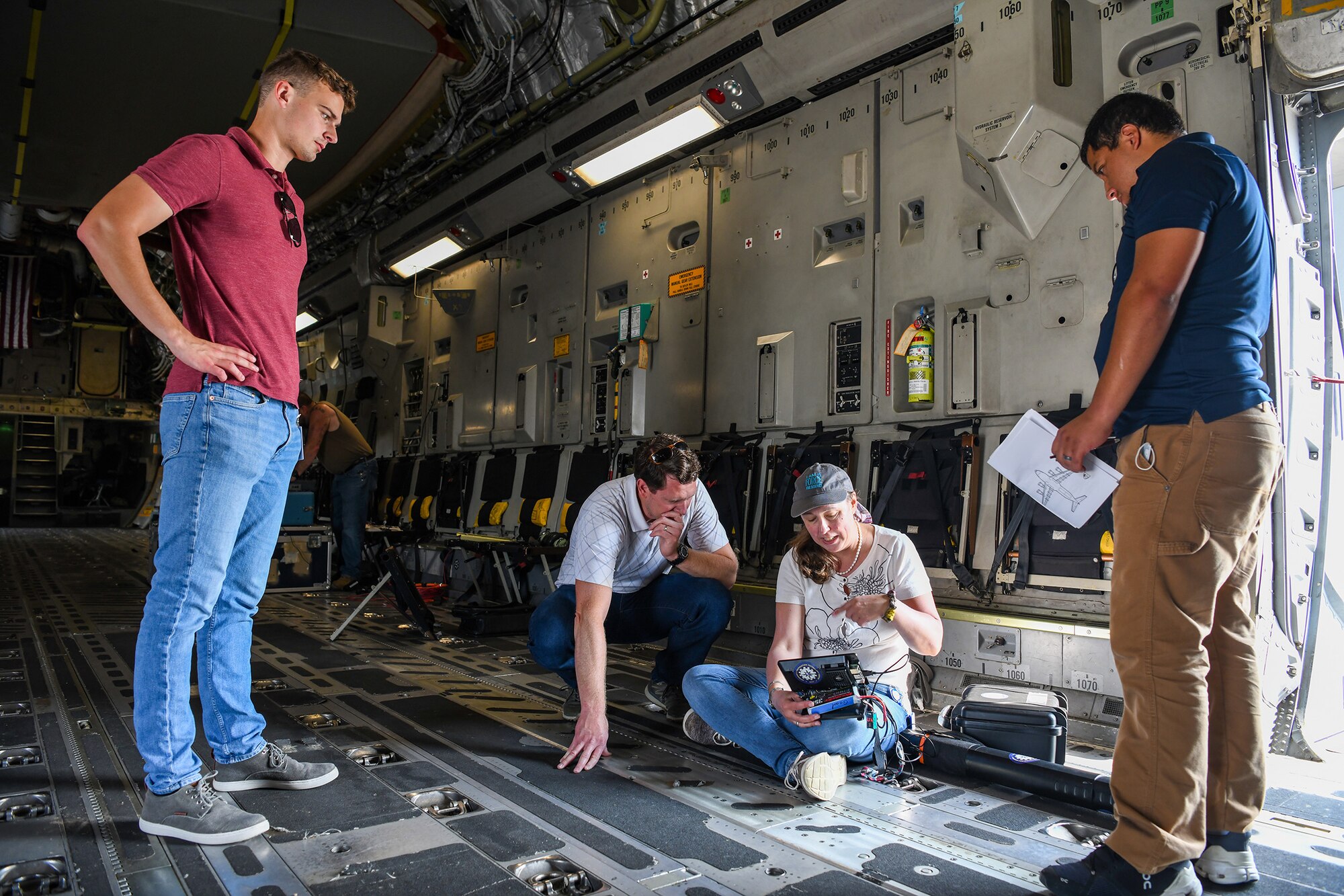 A team from the Air Force Institute of Technology, Air Force Research Lab, and Department of the Air Force/Massachusetts Institute of Technology Artificial Intelligence Accelerator prepare a Mag in a Box, a navigation system for GPS denied environments, for testing on a 445th Airlift Wing C-17 Globemaster III Aug 6, 2021. A team from the Air Force Institute of Technology, Air Force Research Lab, and Department of the Air Force/Massachusetts Institute of Technology Artificial Intelligence Accelerator are working on magnetic-navigation research and brought a stand-alone sensor to test on the C-17 help characterize the platform.