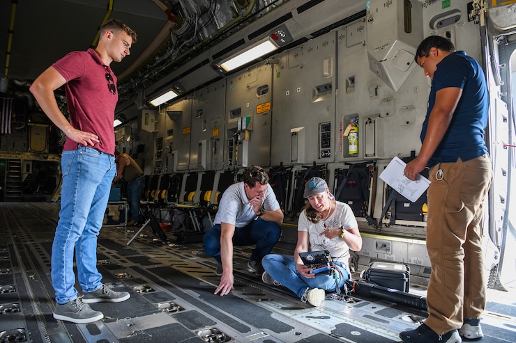 A team from the Air Force Institute of Technology, Air Force Research Lab, and Department of the Air Force/Massachusetts Institute of Technology Artificial Intelligence Accelerator prepare a Mag in a Box, a navigation system for GPS denied environments, for testing on a 445th Airlift Wing C-17 Globemaster III Aug 6, 2021. A team from the Air Force Institute of Technology, Air Force Research Lab, and Department of the Air Force/Massachusetts Institute of Technology Artificial Intelligence Accelerator are working on magnetic-navigation research and brought a stand-alone sensor to test on the C-17 help characterize the platform.