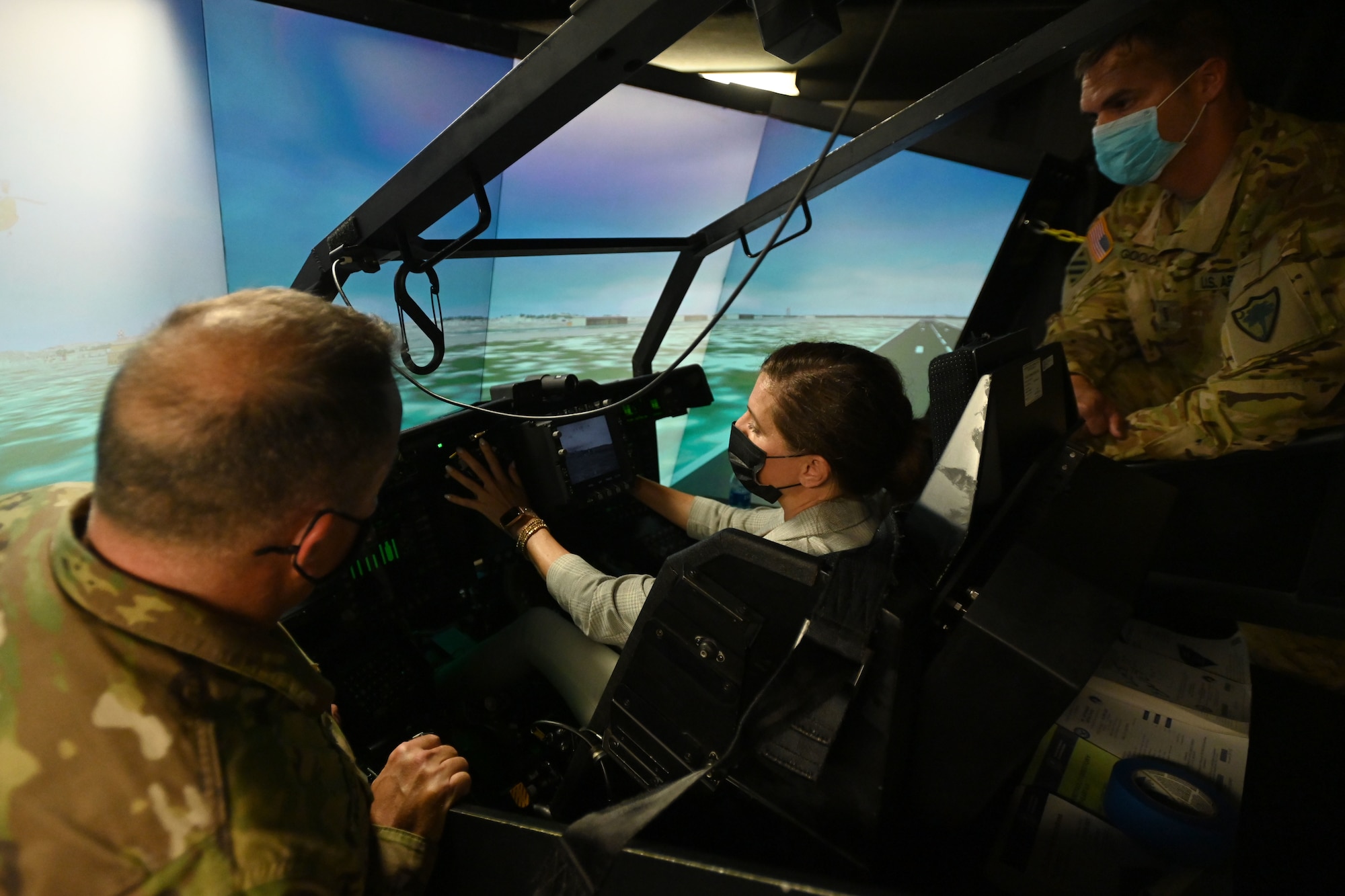 U.S. Rep. Nancy Mace from Charleston, South Carolina receives an in-flight demonstration of the AH-64 Apache helicopter simulator at the South Carolina Army National Guard’s aviation facility located at McEntire Joint National Guard Base, South Carolina Aug. 19, 2021. U.S. Army Col. John McElveen, 59th Troop Command commander, foreground, and U.S. Army Chief Warrant Officer 4 Joel Gooch, 1-151st Attack Reconnaissance Battalion pilot, offer instruction on the flight characteristics of the Apache while Mace operates the flight controls. The purpose of her visit is to meet with South Carolina National Guard leadership to discuss the current state of the South Carolina National Guard and future endeavors for the organization as well as a familiarization of McEntire Joint National Guard Base and the capabilities of the units housed there. (U.S. Air National Guard photo by Senior Master Sgt. Edward Snyder, 169th Fighter Wing Public Affairs)