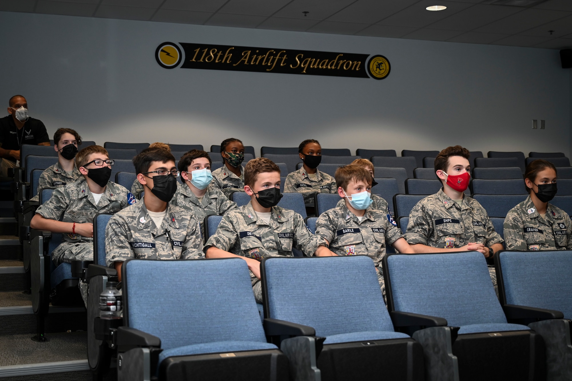 Civil Air Patrol cadets from the Connecticut Wing’s Danielson and Plainville squadrons listen to a 103rd Airlift Wing mission briefing during a tour of Bradley Air National Guard Base in East Granby, Connecticut, Aug. 13, 2021. Cadets got an up-close look at C-130H aircraft, the engines that power them, and learned about the 103rd Airlift Wing’s mission. (U.S. Air National Guard photo by Tech. Sgt. Steven Tucker)