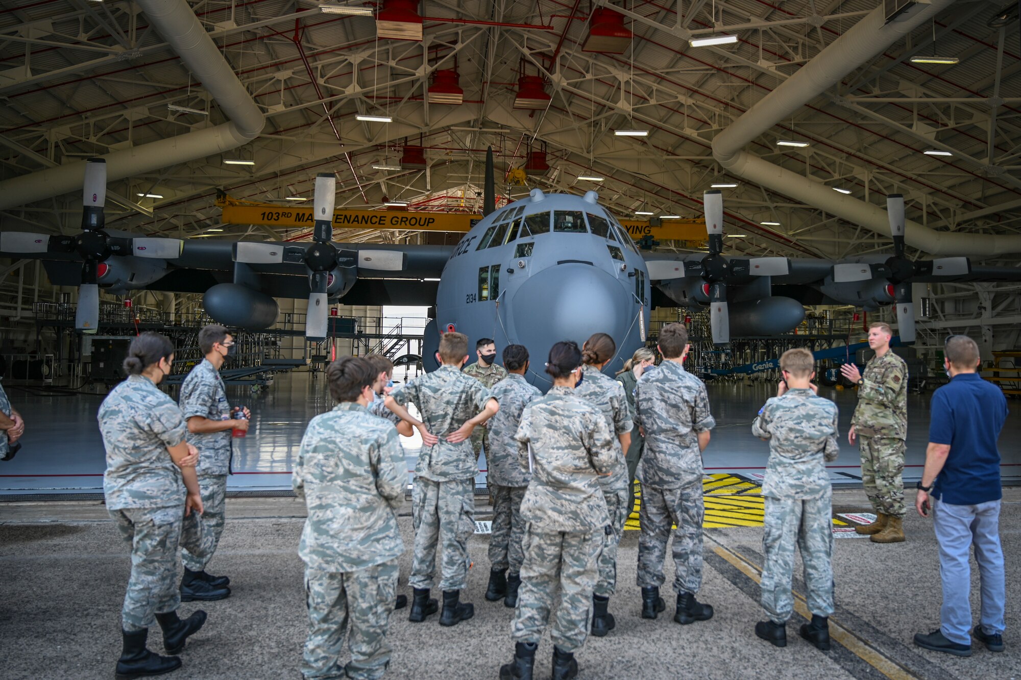 U.S. Air Force 2nd Lt. John Lane (right), assigned to the 103rd Maintenance Squadron, briefs Civil Air Patrol cadets on the 103rd Airlift Wing’s C-130H Hercules tactical airlift mission during a tour of Bradley Air National Guard Base in East Granby, Connecticut, Aug. 13, 2021. Cadets from the Connecticut Wing’s Danielson and Plainville squadrons got an up-close look at C-130H aircraft, the engines that power them, and learned about the 103rd Airlift Wing’s mission. (U.S. Air National Guard photo by Tech. Sgt. Steven Tucker)