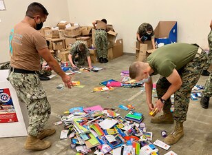 LEMOORE, Calif. (Aug. 20, 2021) Sailors and Marines at the Center for Naval Aviation Technical Training Unit Lemoore sort through school supplies as part of their "Backpack Brigade"  effort to give local and military families school supplies for the 2021 school year. (U.S. Navy photo)