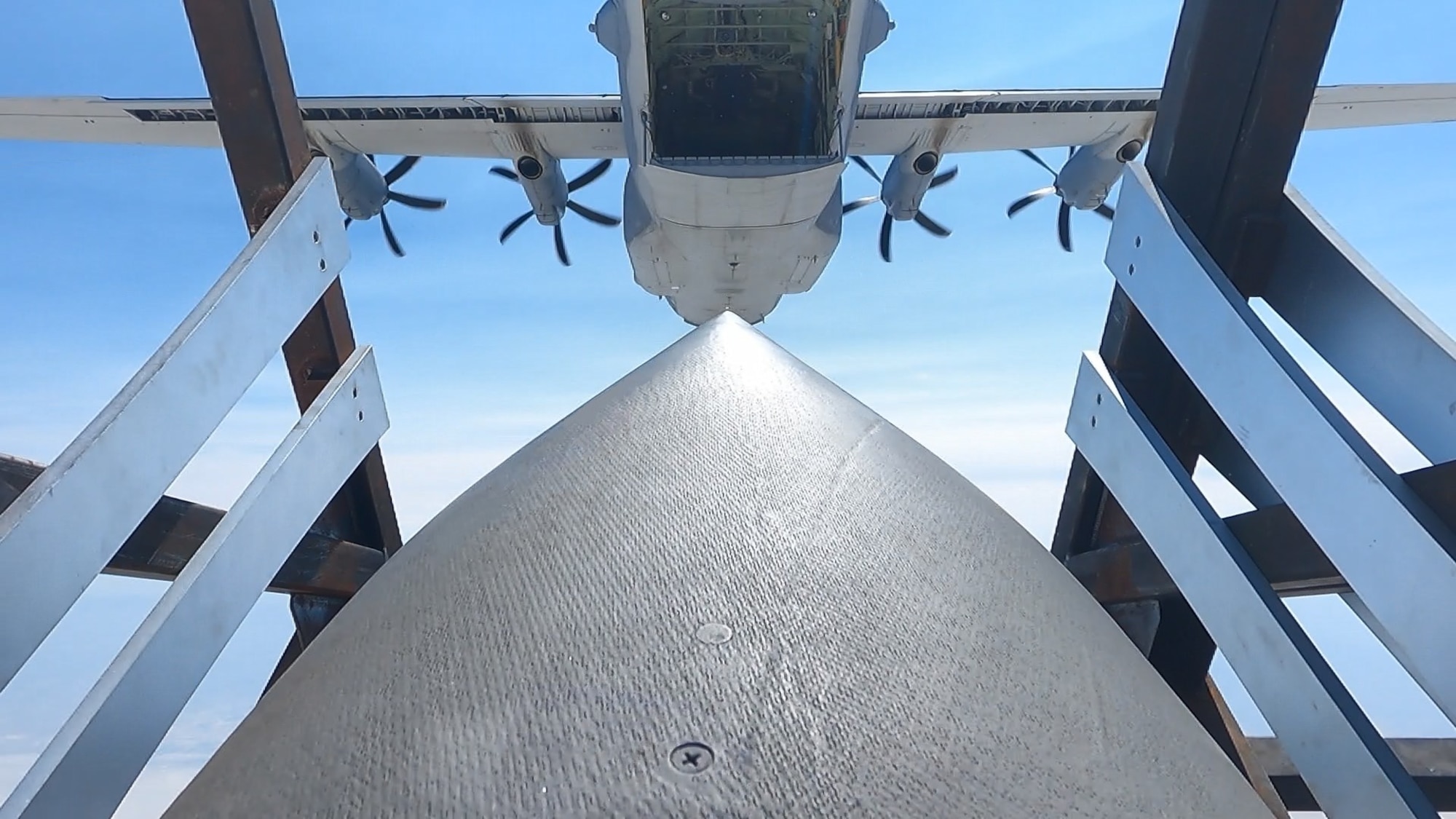 An airdropped Palletized Munition Deployment System carrying JASSM-ER simulants. The photo shows one of the JASSM-ER cruise missiles in the Deployment Box immediately after being airdropped from an EC-130SJ. (Courtesy photo)