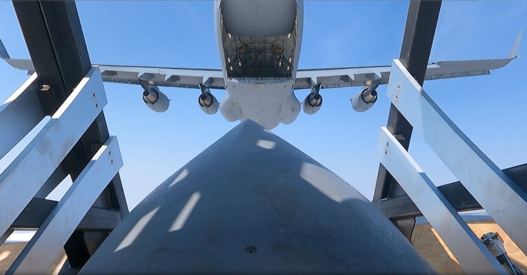 An airdropped Palletized Munition Deployment System carrying JASSM-ER simulants. The photo shows one of the JASSM-ER cruise missiles in the Deployment Box immediately after being airdropped from a C-17A. (Courtesy photo)