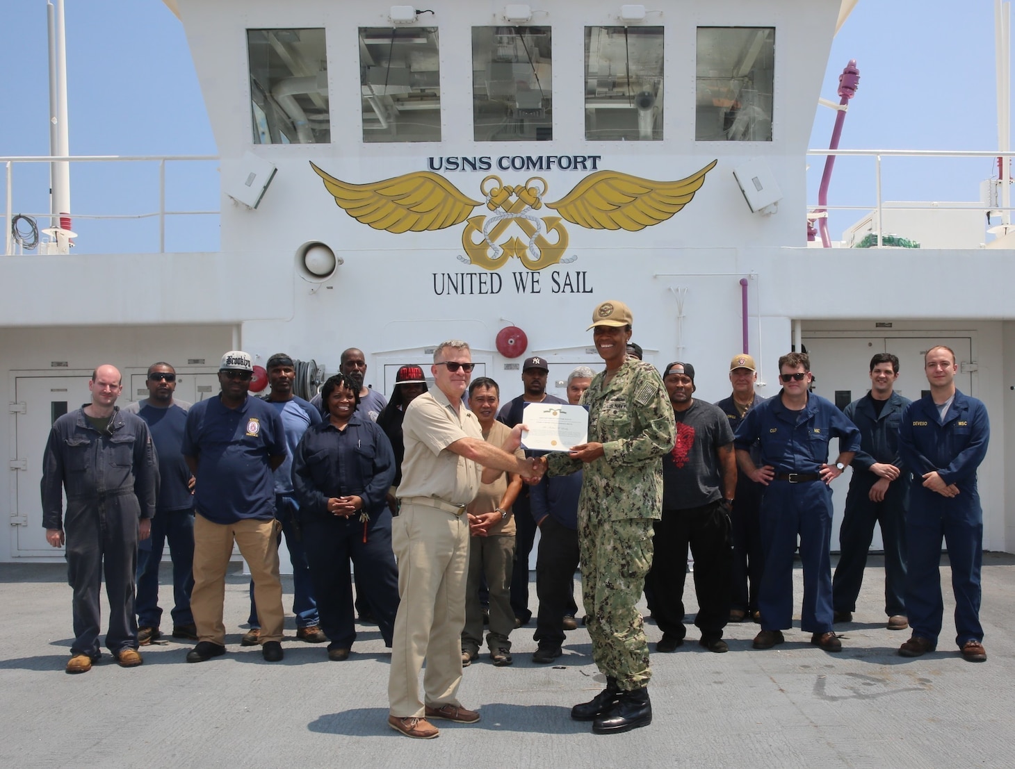 Capt. Janice G. Smith, Commodore, Military Sealift Command Atlantic, presents the Armed Forces Civilian Service Medal to Capt. Andrew Lindey, master of USNS Comfort.