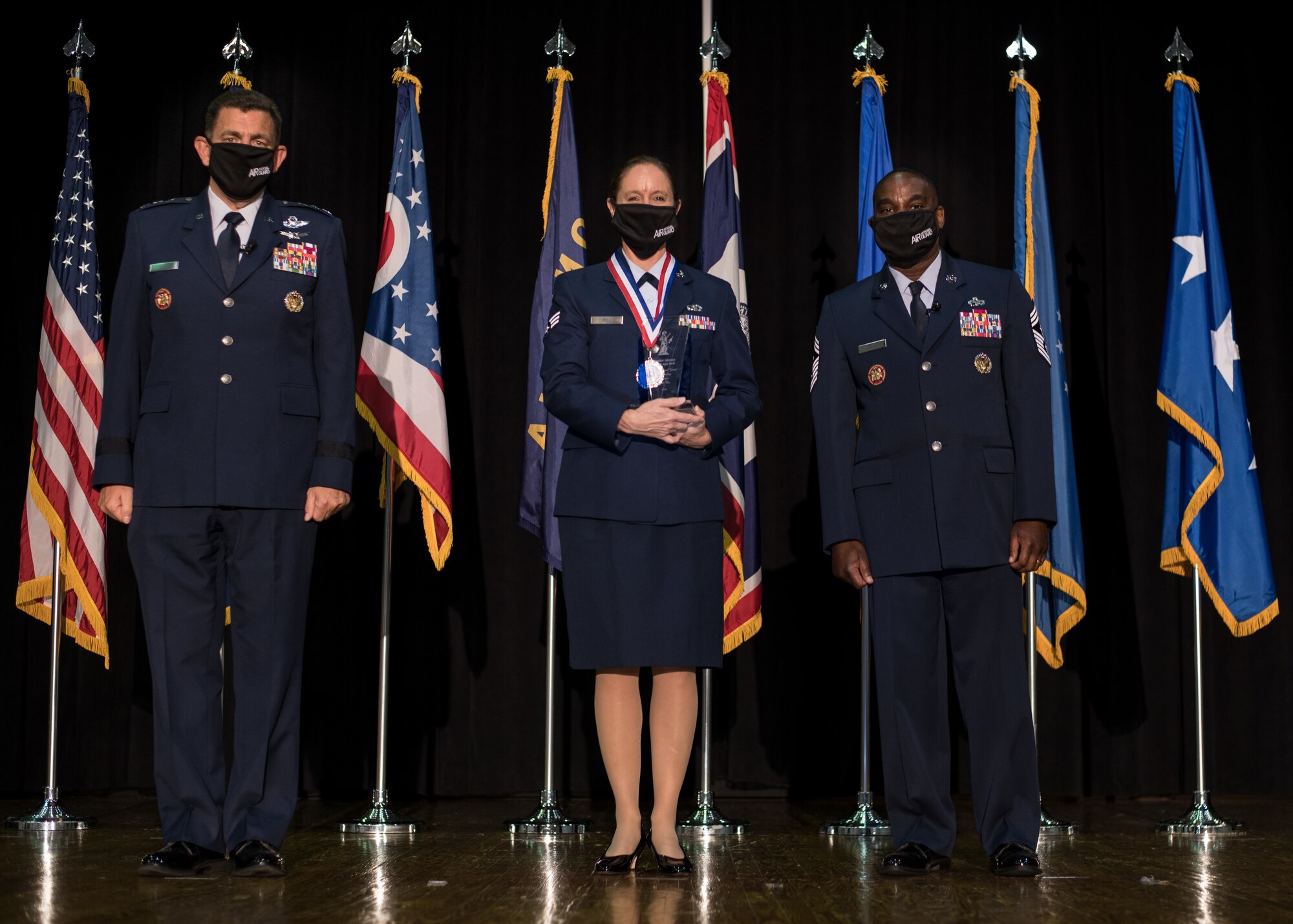 U.S. Air Force Senior Airman Ruth-Ann Bell, with the 193rd Special Operations Wing, Pennsylvania National Guard, poses for a photo with Lt. Gen. Michael A. Loh, left, director, Air National Guard (ANG), and Chief Master Sgt. Maurice L. Williams, command chief, ANG, during the Outstanding Airmen of the Year ceremony at Joint Base Andrews, Maryland, Aug. 19, 2021. Bell was recognized as the ANG’s Airman of the Year during Focus on the Force Week 2021—an annual event hosted by the ANG command chief that highlights professional development and celebrates the accomplishments of the top performing members of the enlisted corps. (U.S. Air National Guard photo by Tech. Sgt. Morgan R. Whitehouse)