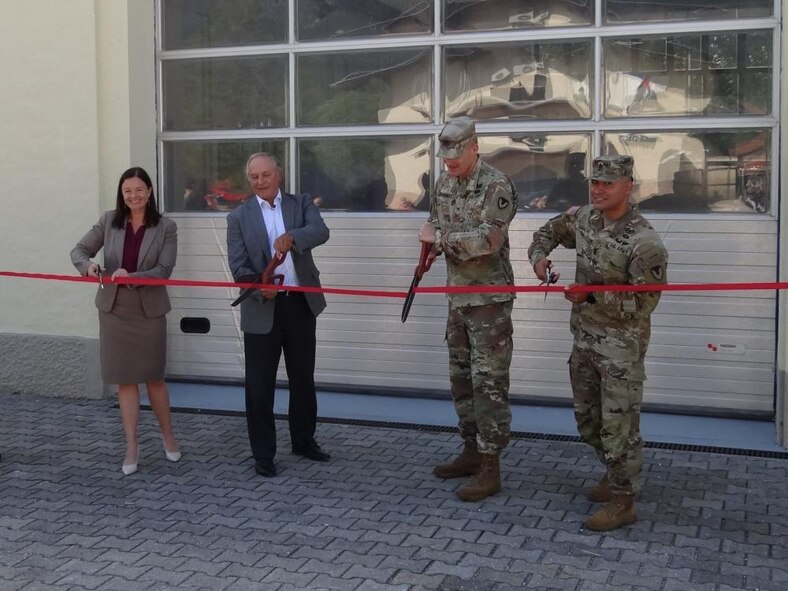 From left to right, Garmisch Garrison Manager Laura Hemming, 405th Army Field Support Brigade Maintenance Manager Juergen Nisi, U.S. Army Garrison Bavaria Commander Col. Christopher Danbeck and Command Sgt. Maj. Sebastian Camacho cut the red ribbon in front of the renovated facility in Garmisch, on Aug. 10, 2021.