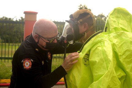 A Weapons of Mass Destruction Civil Support Team member's protective suit is inspected before the member responds to a potential chemical, biological, or radiological threat while participating in a training event in the municipality of Carolina, Puerto Rico, Aug. 18, 2021. The training scenarios include response, evaluation, testing, and securing the area of contamination. The members are made up of soldiers and airmen from the 33rd WMD-CST, District of Columbia National Guard, along with other CST's from Texas, North Carolina, West Virginia, Puerto Rico and the District of Columbia Fire and Emergency Management Service.
