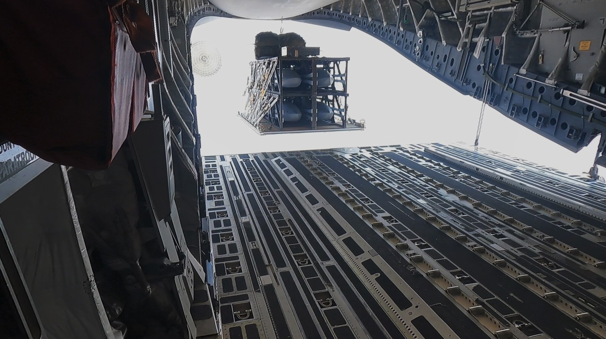 A standard cargo airdrop of the Palletized Munition Deployment System from a C-17A. A 4-pack configuration is used for demonstration purposes. (Courtesy photo)
