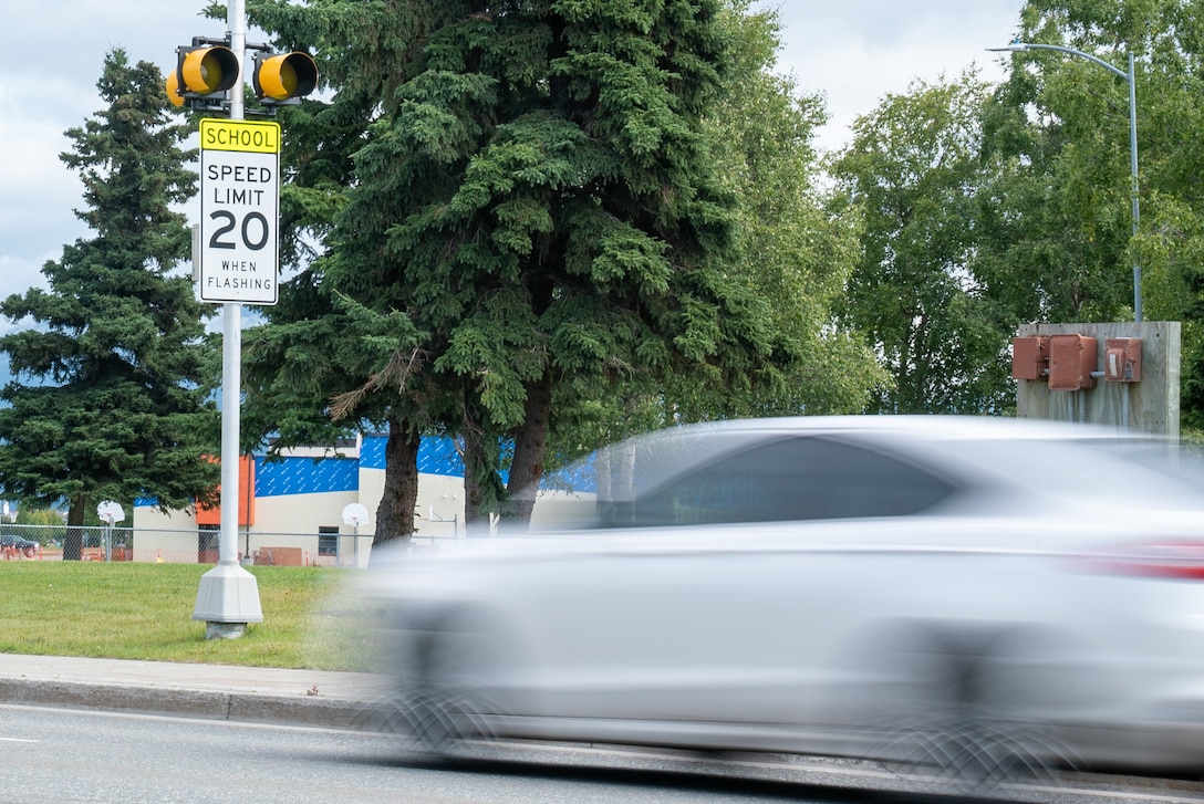 A car drives by a back to school sign on Joint Base Elmendorf-Richardson.