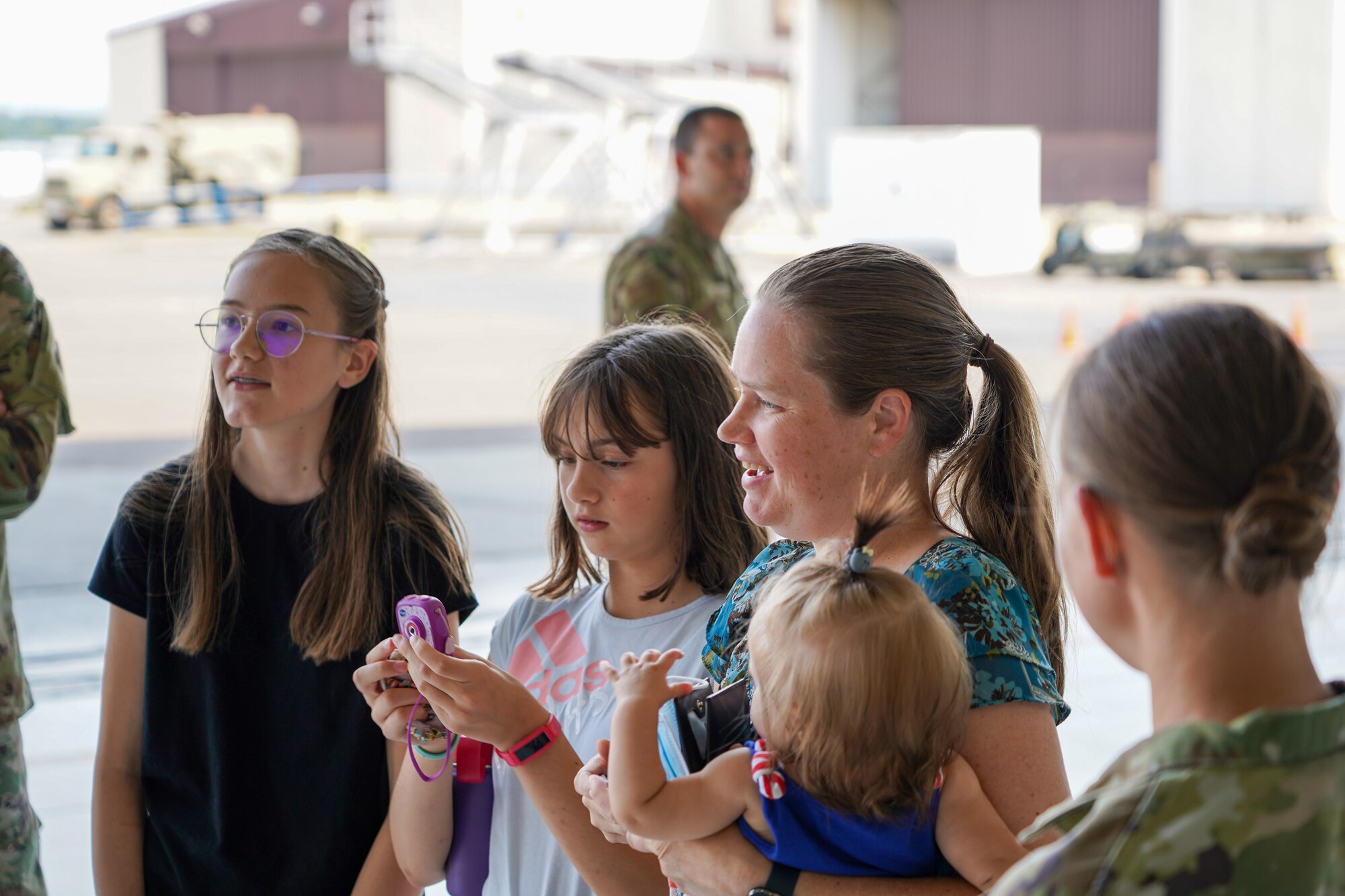 Leah Ketchum and her family admire a 142nd Wing F-15 Eagle that now displays her artwork on its nose on August 12, 2021 in Portland, Ore. The 142nd Wing and the 173rd Fighter Wing both held contests in support of Month of the Military Child in which each wing chose one winner to have their designs applied to fighter jets at their respective wings. (U.S. Air National Guard Photo by Staff. Sgt. Alexander Frank)